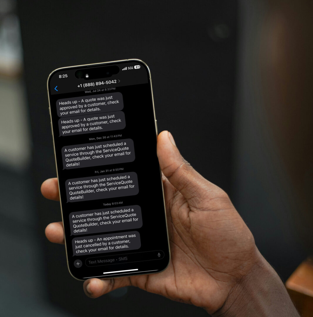 Hand holding smartphone displaying text messages.