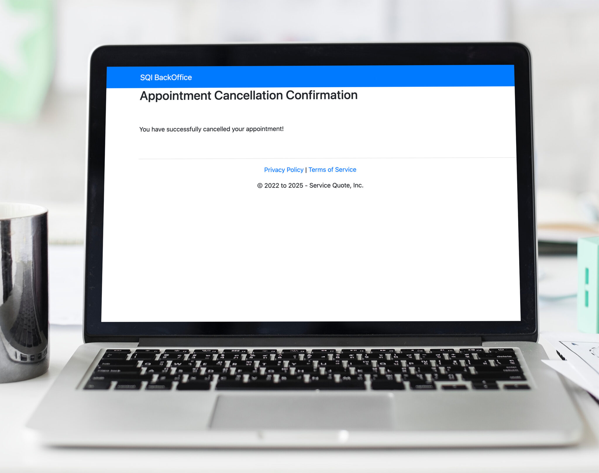 Laptop displaying appointment cancellation confirmation message.